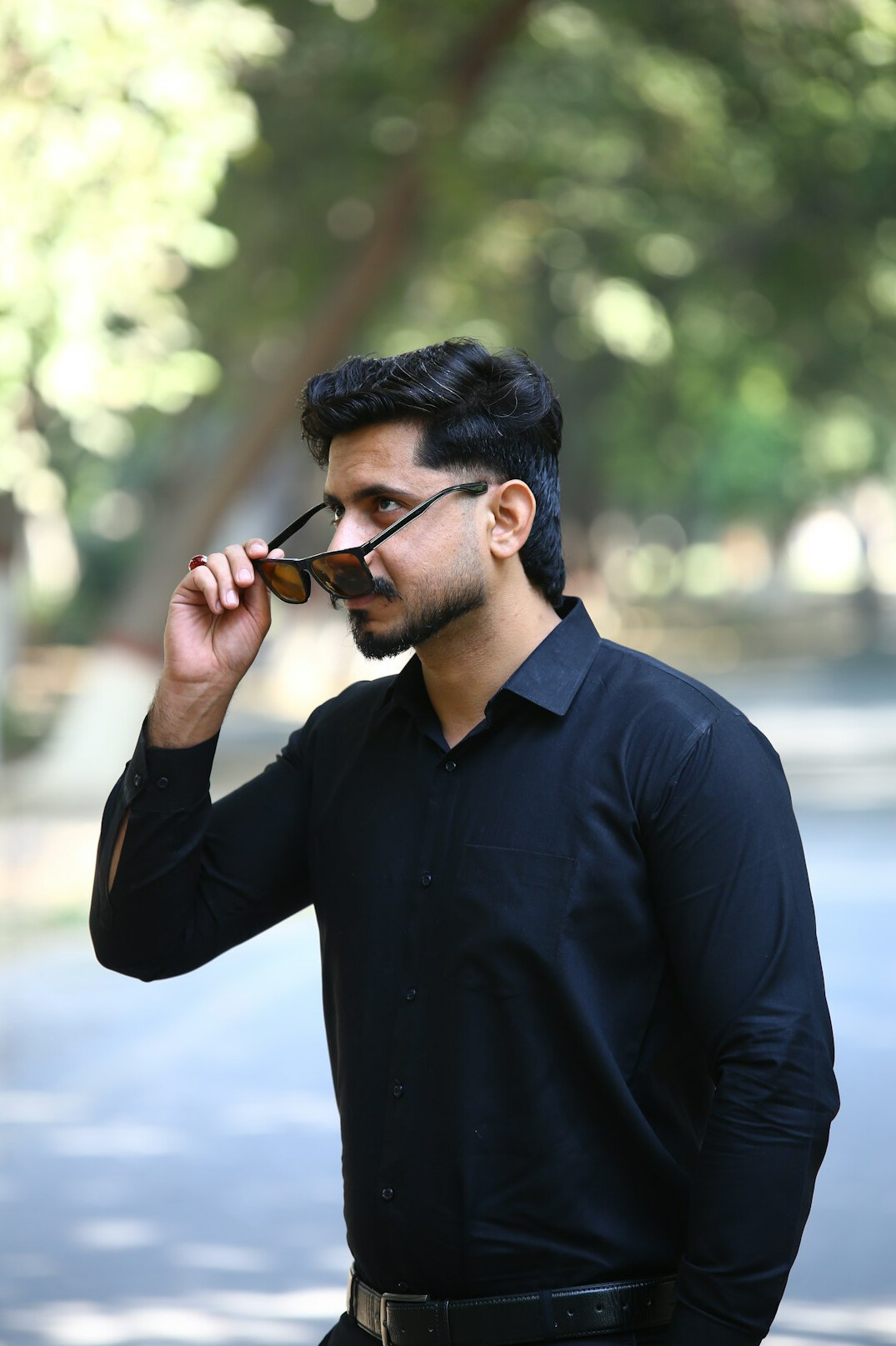 Portrait of a man with a beard and glasses in business casual clothes